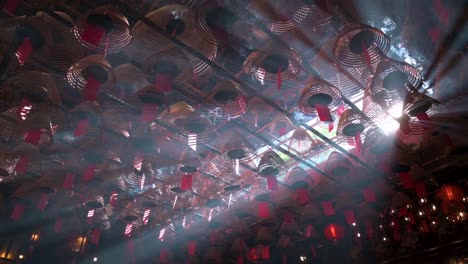 Incense-coils-hanging-from-the-ceiling-as-they-burn-inside-a-Taoist-temple-to-attract-the-attention-of-the-gods-in-Hong-Kong