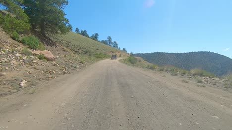 POV-following-another-vehicle-up-a-logging-road-in-mountains-of-Colorado---easy-off-road-expedition