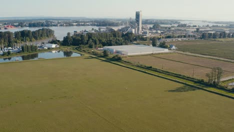 Aerial-fly-over-farming-cranberries-marijuana-canabis-thc-cement-in-Richmond-BC-Canada-right-by-the-fraser-River-where-boats-are-dry-docked-for-repair-and-transport-cargo-for-import-export-services