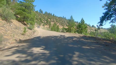 POV-following-another-vehicle-up-a-gravel-mountains-pass-in-the-Rocky-Mountains-of-Colorado---fun-off-road-expedition