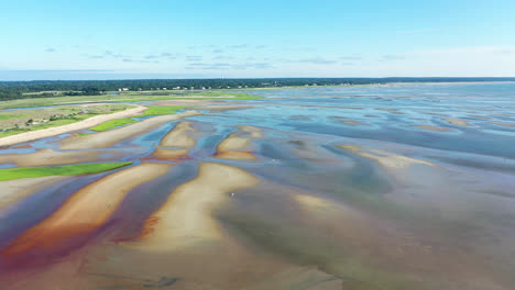 Cape-Cod-Bay-Aerial-Drone-Footage-of-Bay-Side-Beach-at-Low-Tide-with-Sand-Dunes-and-People-Walking-in-Ocean