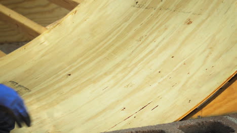 Flattening-wooden-ramp-deck-manually-with-human-weight-closeup