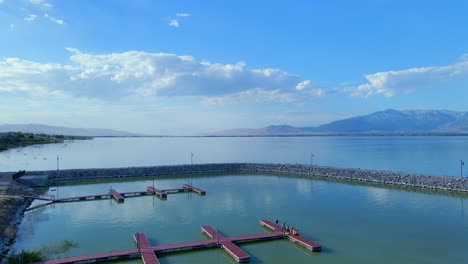 Fixed-shot-across-the-Saratoga-Springs-Marina-opening-out-into-Utah-Lake-with-two-red-pontoons-sticking-out