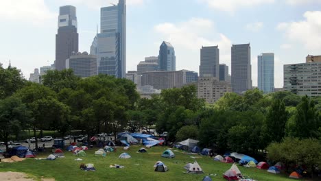 Protesters-in-Black-Lives-Matter-BLM-camp-on-public-park-in-urban-city,-Philadelphia,-USA,-public-protest-theme,-aerial-view