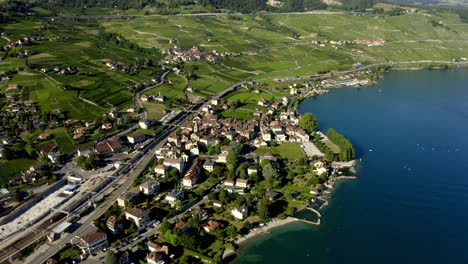 Cully-Village-Waterfront-Houses-Along-The-Lake-Leman-In-Lavaux-Vineyard-Terraces,-Switzerland---aerial-drone-shot