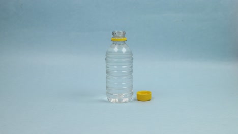 Clear-water-drinks-from-a-bottle-on-a-blue-background---Stop-motion