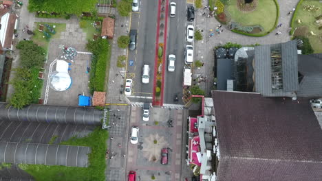 Street-from-above-with-cars-passing-and-people-walking