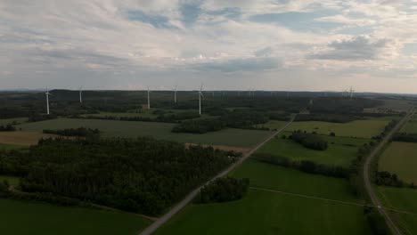 Green-Fields-And-Meadow-Near-The-Wind-Farm-On-A-Cloudy-Day-In-Quebec,-Canada
