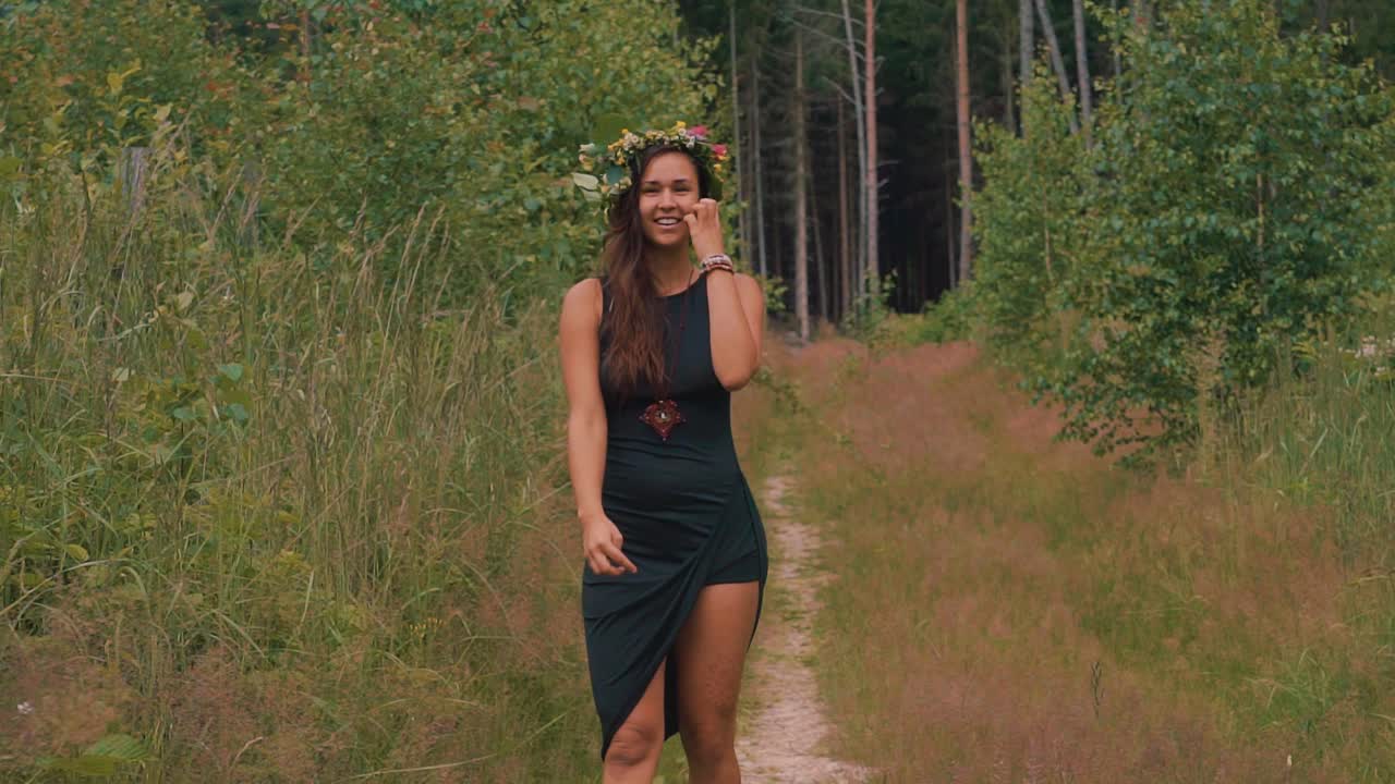 A pretty black girl in a black dress in a forest, sc