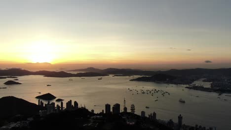 Sunset-over-Hong-Kong-bay-islands,-Aerial-view-facing-the-Setting-Sun