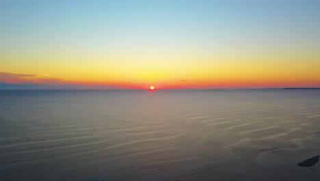 Beautiful-Ocean-Sun-Set-Aerial-Drone-Footage-of-Sun-Touching-Horizon-and-Colorful-Yellow,-Red-and-Blue-Sky