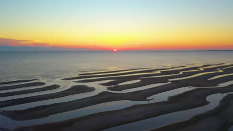 Cape-Cod-Bay-Colorful-Sun-Set-Aerial-Drone-Footage-of-Beach-at-Low-Tide-with-Sand-Bars-and-Puddles