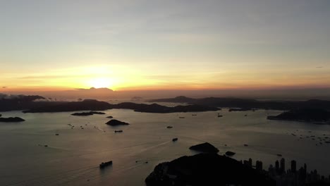 Sunset-over-Hong-Kong-bay-islands,-Aerial-view-facing-the-Setting-Sun