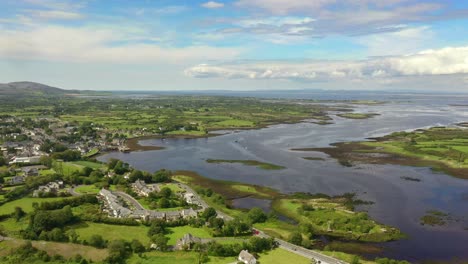 Kinvara,-Galway,-Ireland,-August-2020,-Drone-flying-high-while-slowly-tracking-parallel-to-fishing-village