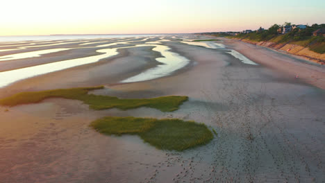 Cape-Cod-Bay-Aerial-Drone-Footage-of-Beach-Front-Houses-at-Low-Tide-with-Lowering-Motion