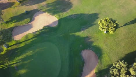 Aerial-view-of-a-hole-area-of-a-golf-course-with-sand-bunkers