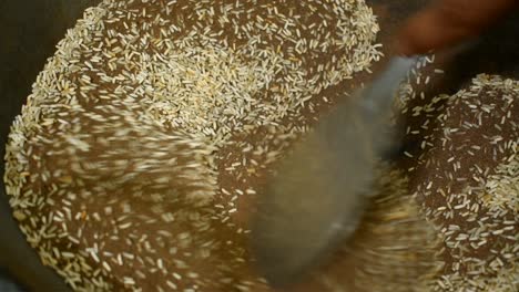 close-up-of-frying-rice-with-sand-in-a-pan