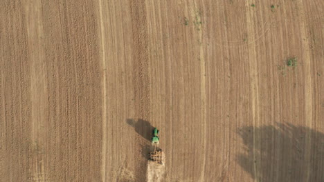 Tractor-Plowing---Tilling-Agricultural-Farmland---Directly-Overhead-Aerial-Drone-View