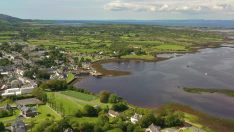 Kinvara,-Galway,-Ireland,-August-2020,-Drone-flying-high-while-slowly-pushing-towards-fishing-village