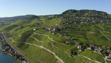 Flying-Towards-Grandvaux-Village-In-Lavaux-Vineyard-Terraces,-Switzerland---aerial-drone-shot