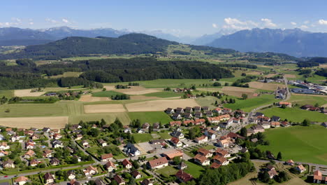 The-Quiet-And-Peaceful-Village-Of-Forel-Surrounded-By-Lush-Fields-And-Meadows-In-Vaud,-Switzerland---aerial-drone