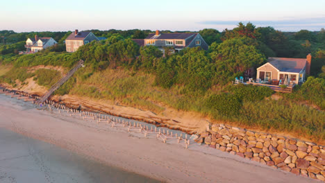 Cape-Cod-Bay-Aerial-Drone-Footage-of-Beach-Front-Houses-at-Low-Tide-with-Lowering-Motion-During-Golden-Hour