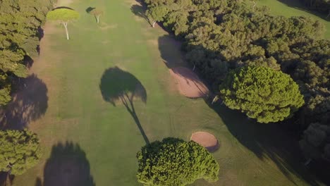 Aerial-ascending-shot-of-a-golf-course-with-bunkers-in-Andalusia