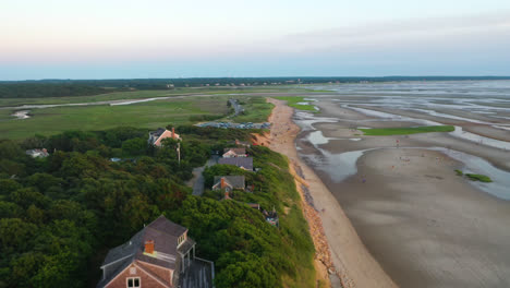 Cape-Cod-Bay-Aerial-Drone-Footage-of-Bay-Side-Beach-at-Low-Tide-with-Sand-Dunes,-Marsh-and-People-Walking-in-Ocean-During-Golden-Hour