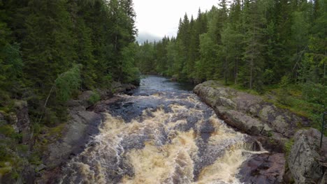 Powerful-Flowing-River-at-Storstupet-Waterfalls-in-Dalarna,-Sweden,-Medium,-Slow-Motion