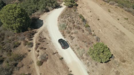 Aerial-view-of-mountain-path-following-car
