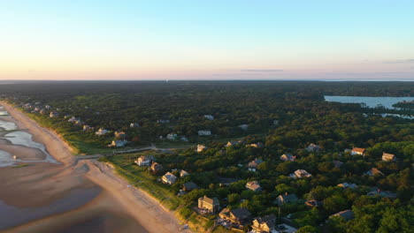 Cape-Cod-Bay-Aerial-Drone-Footage-of-Beach-Front-Houses,-Trees-and-Marsh-at-Low-Tide-During-Golden-Hour,-Pan-Right