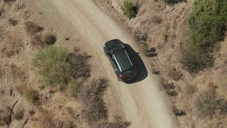 Aerial-view-of-car-driving-at-a-mountain-path