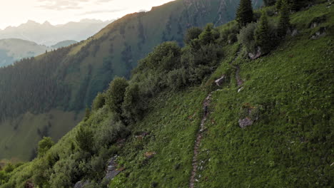 Bird-Eye-View-of-Lone-Trekker-Walking-Up-Along-Mountain-Trail-at-Sunrise