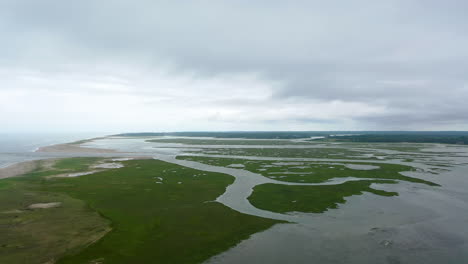 Ominous-Aerial-Drone-Footage-Marsh-and-Ocean-on-Dark-Cloudy-Day-in-Cape-Cod,-Massachusetts