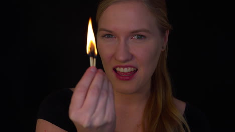 Young-woman-is-playing-with-a-fire