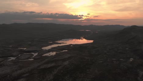 Distant-mountain-lake-at-sunset.--Drone-footage