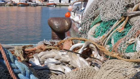 Coloured-Fishing-Nets-Stacked-on-the-Pier-near-the-Boat-and-Bollard-to-Wrap-the-Mooring-Lines