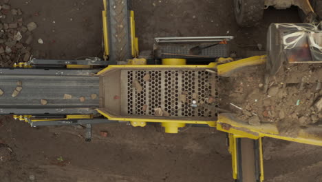 Aerial-top-down-view-of-construction-waste-sorter-machine-on-cloudy-day
