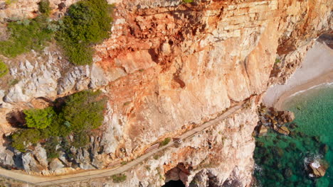 Beautiful-cliffside-walkway-on-Croatian-Adriatic-Sea-coastline,-aerial-view