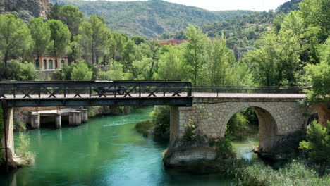 Car-driving-over-the-old-bridges-of-Lago-de-Bolarque-Spain
