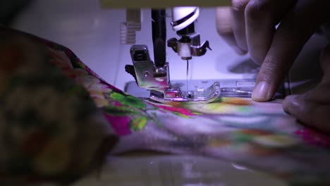 Tailor-women-operating-a-Sewing-Machine-process-in-slow-motion,-fast-stitching-needle-work-in-the-machine-under-white-light