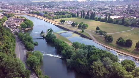 Flying-over-the-beautiful-River-Exe-in-Exeter,-England,-with-cityscape-background