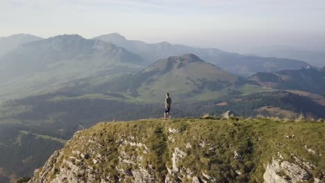 Camera-follow-a-young-hiker-who-walks-down-a-huge-mountain-ridge-in-Switzerland-in-October