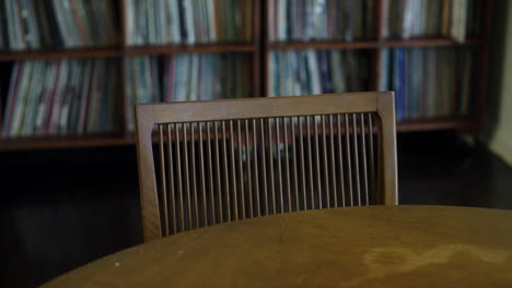 SLOW-MOTION-footage-of-wooden-chair-at-a-table-in-study-room