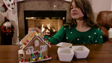 Pretty-Woman-Decorating-Gingerbread-House-by-the-Fire