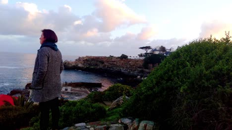 Women-looking-out-over-ocean-at-lookout-point-searching-for-whales-in-Hermanus
