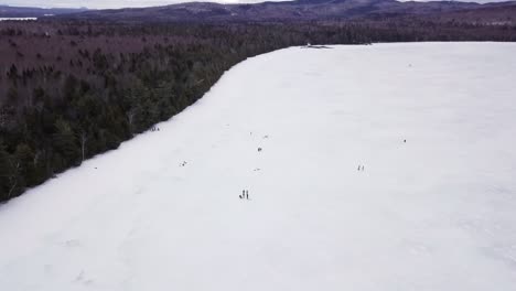Get-an-aerial-view-of-Ice-Fishing-on-Fitzgerald-Pond,-Maine
