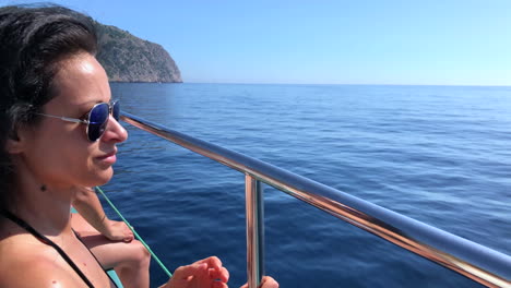 Woman-on-a-boat-sailing-through-the-Mediterranean-Sea,-along-the-coast-of-Palma-de-Mallorca