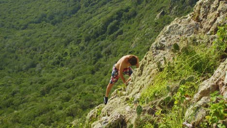 In-this-footage-you-can-see-man-climbing-on-the-steep-rock-on-Christoffelberg,-Curacao-island