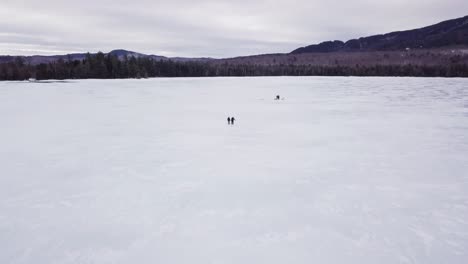 Get-an-aerial-view-of-Ice-Fishing-on-Fitzgerald-Pond,-Maine